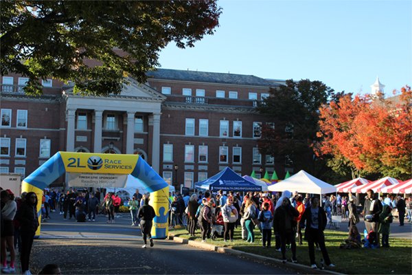 Crowds gather among autumn leaves at the Reading Hospital Road Run 2024